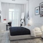 camera da letto bianca con muro di mattoni