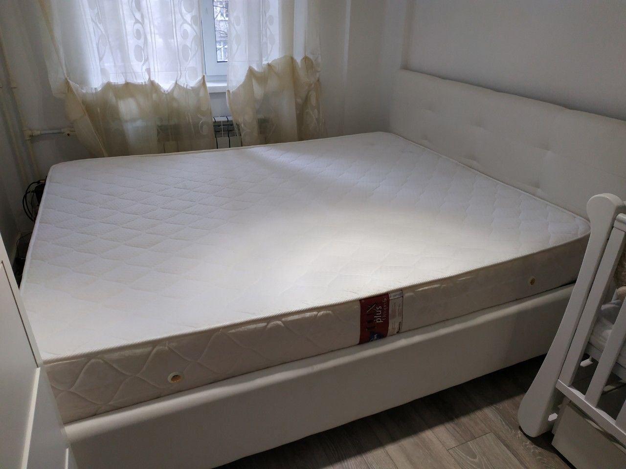 the creak of an expensive mattress